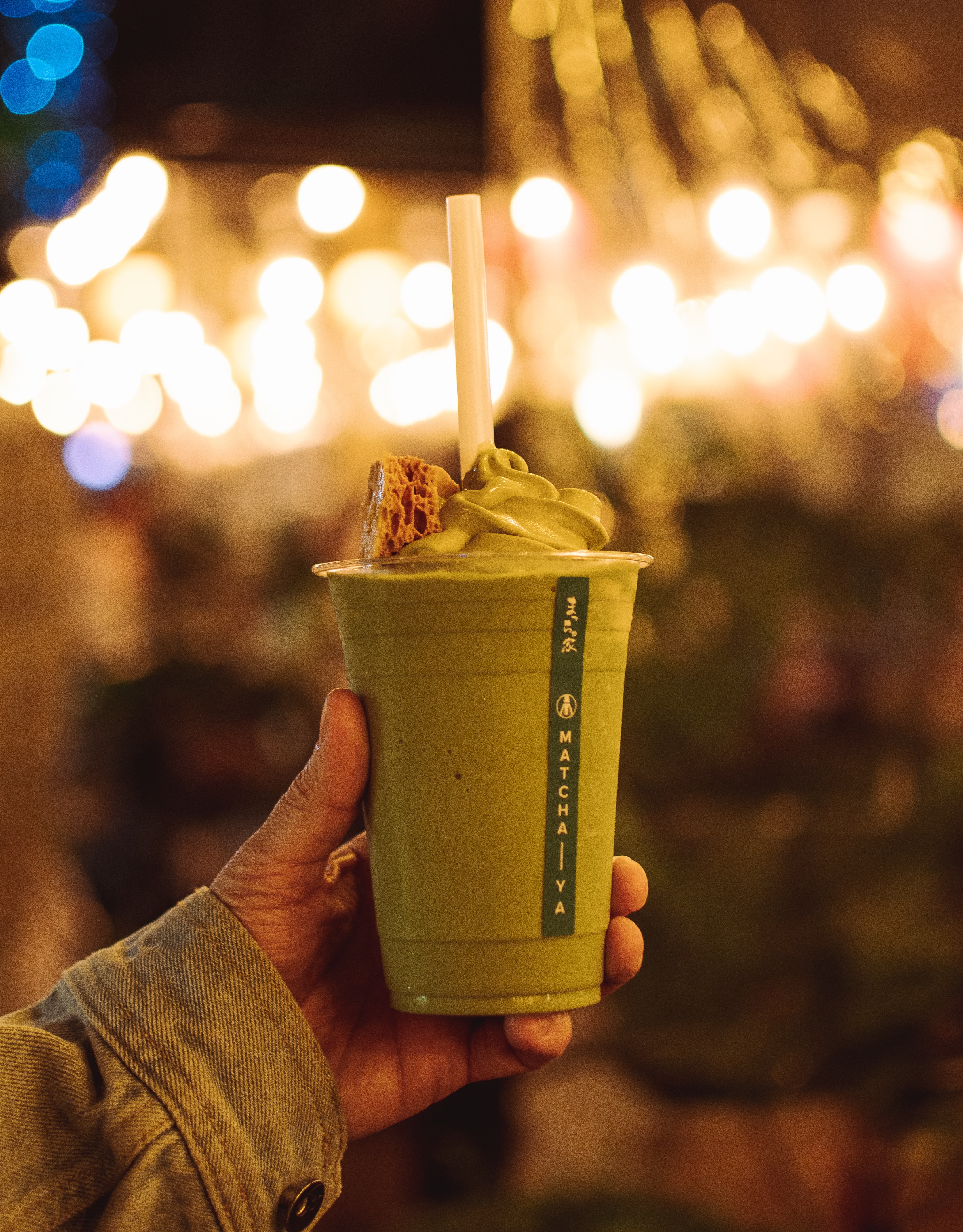 Person holding green coffee beverage