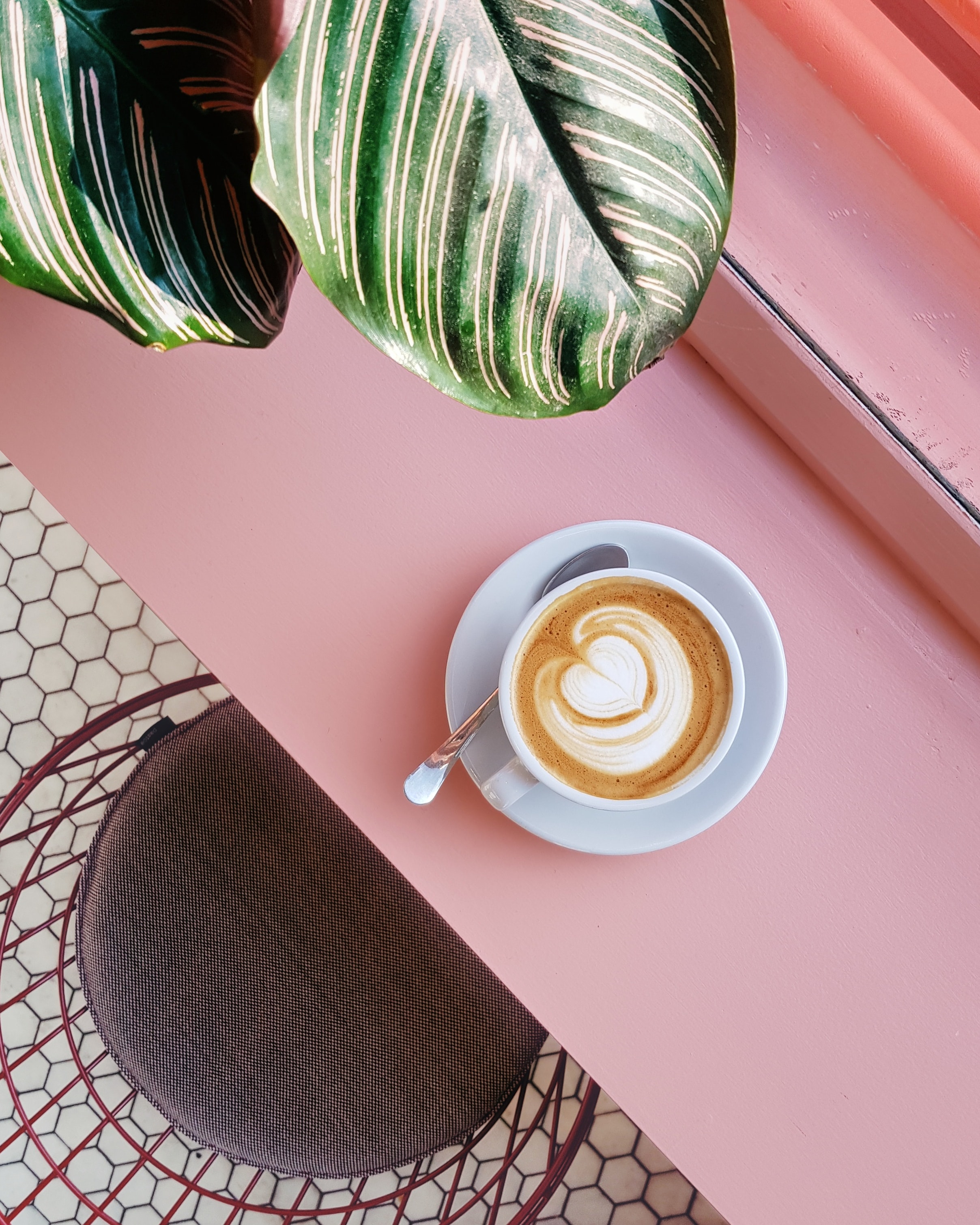 Cup of coffee on a pink windowsill